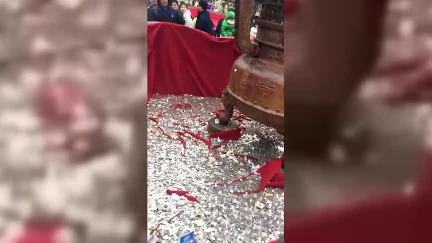 [视频]游客寺庙祈福扔硬币 寺里义工一天打扫几麻袋
